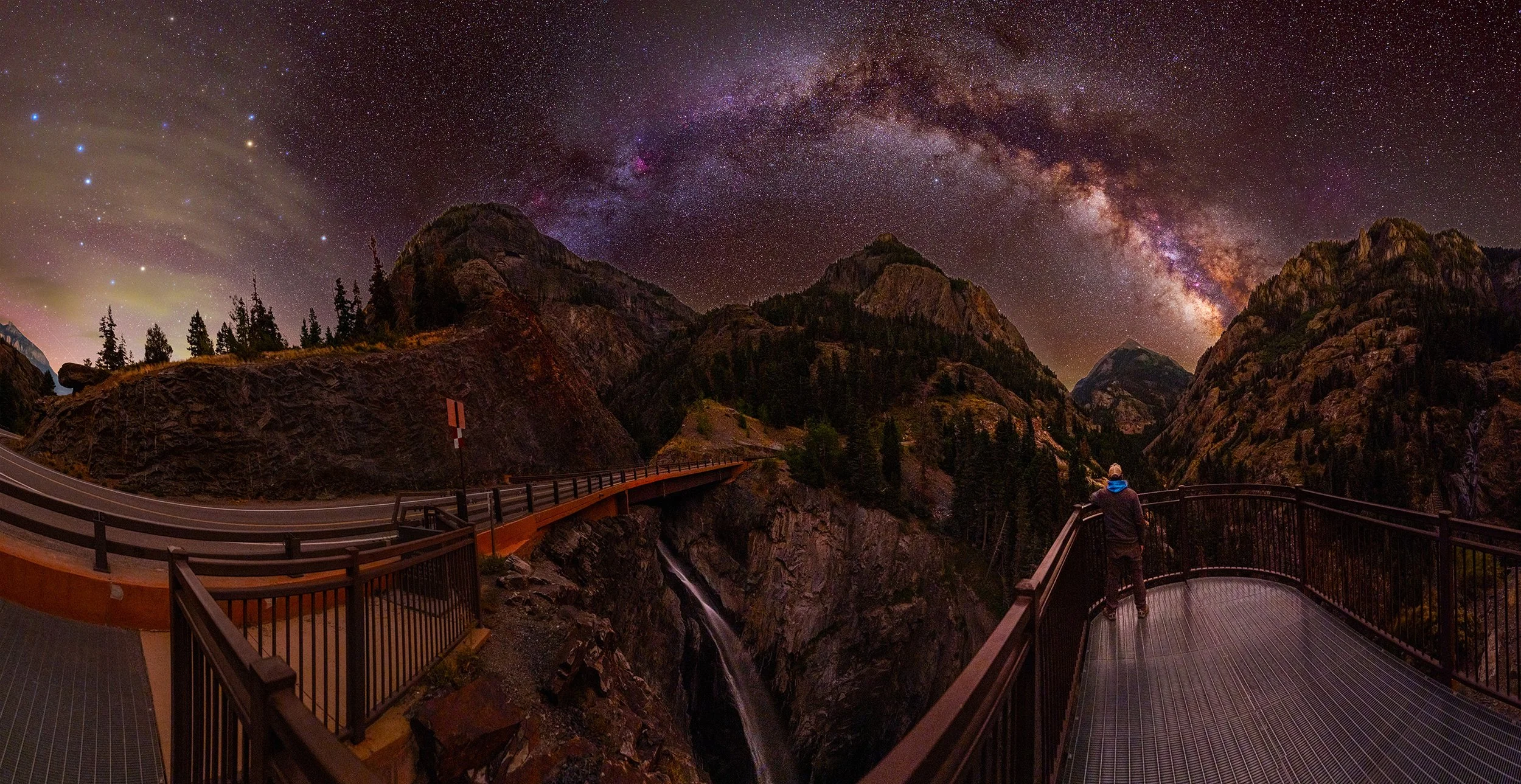 Sam Groth photographing the Milky Way above a mountain canyon